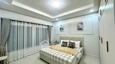 Elegant bedroom with modern decor and ample natural light