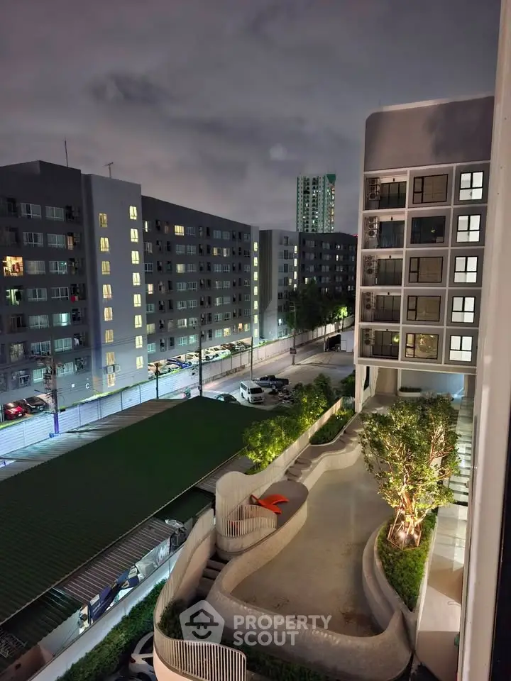 Modern apartment complex with night view, showcasing contemporary architecture and well-lit surroundings.