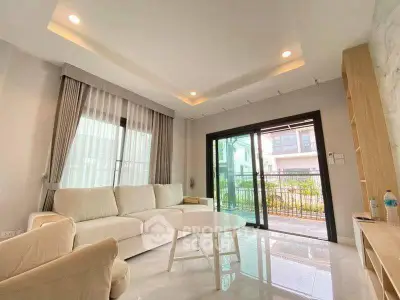 Bright and spacious living room with modern decor and large windows