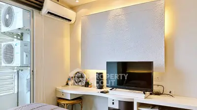 Modern study room with sleek desk, wall-mounted TV, and air conditioning unit, perfect for productivity.