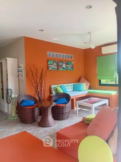 Vibrant living room with colorful decor and modern furniture, perfect for relaxation and entertaining.