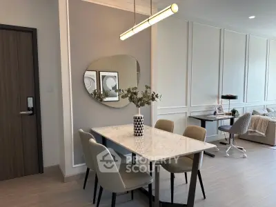 Modern dining area with elegant marble table and stylish decor in a contemporary apartment.