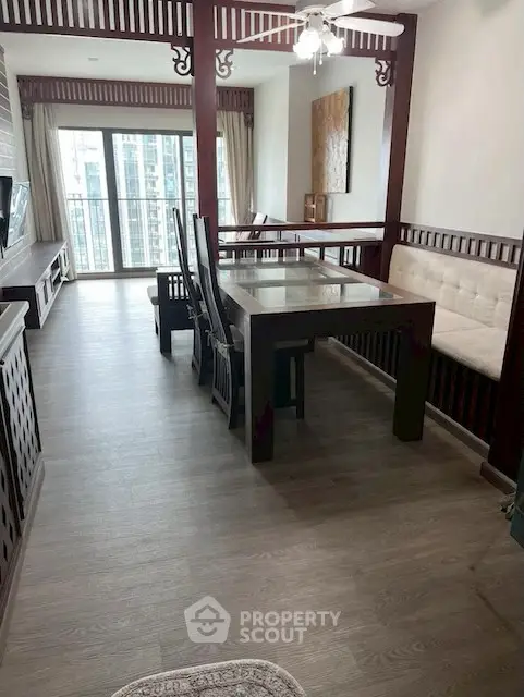 Elegant dining area with wooden accents and large windows offering city views.