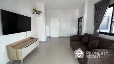 Spacious living room with glossy tiled flooring, large windows, and modern furnishings including a plush brown sofa and sleek entertainment unit.