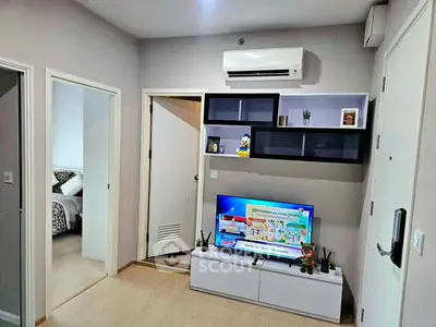 Modern living room with sleek furniture and air conditioning, showcasing a cozy and inviting atmosphere.