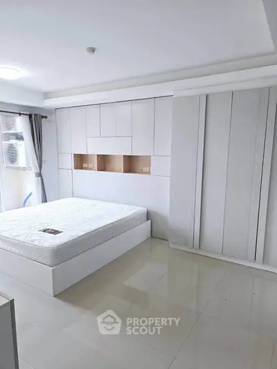Modern minimalist bedroom with built-in storage and natural light