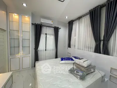 Modern bedroom with elegant curtains and built-in storage in a stylish home.