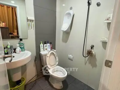Modern bathroom with sleek fixtures and ample storage space, perfect for urban living.