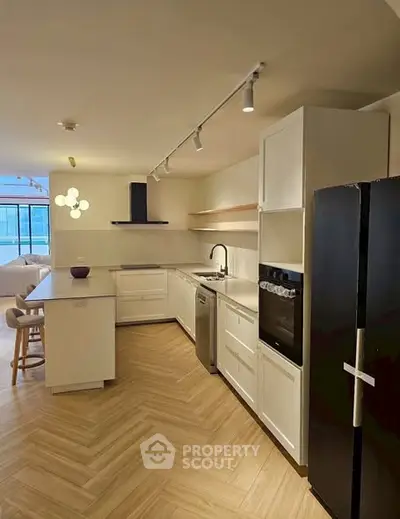 Modern kitchen with sleek appliances and open layout in a stylish apartment.