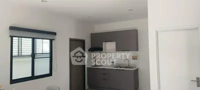 Modern kitchen with sleek cabinetry and ample natural light