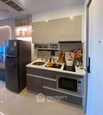 Modern kitchen with sleek cabinetry and built-in appliances in a stylish apartment.