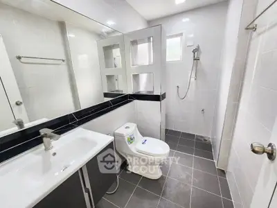 Modern bathroom with sleek fixtures and spacious shower area