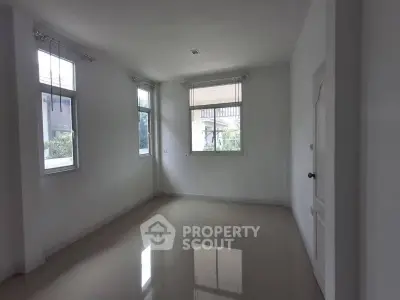 Spacious empty room with large windows and glossy floor, perfect for customization.