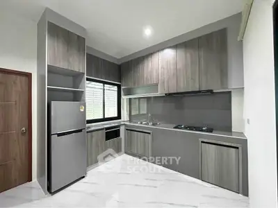 Modern kitchen with sleek cabinetry and stainless steel appliances in a stylish home.