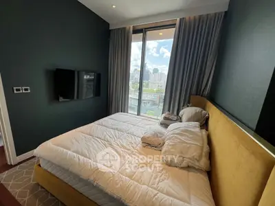Luxurious bedroom with city view and modern decor, featuring a plush bed and wall-mounted TV.