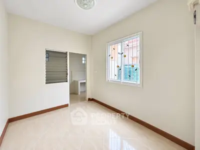 Spacious unfurnished room with tiled flooring and large window in modern home