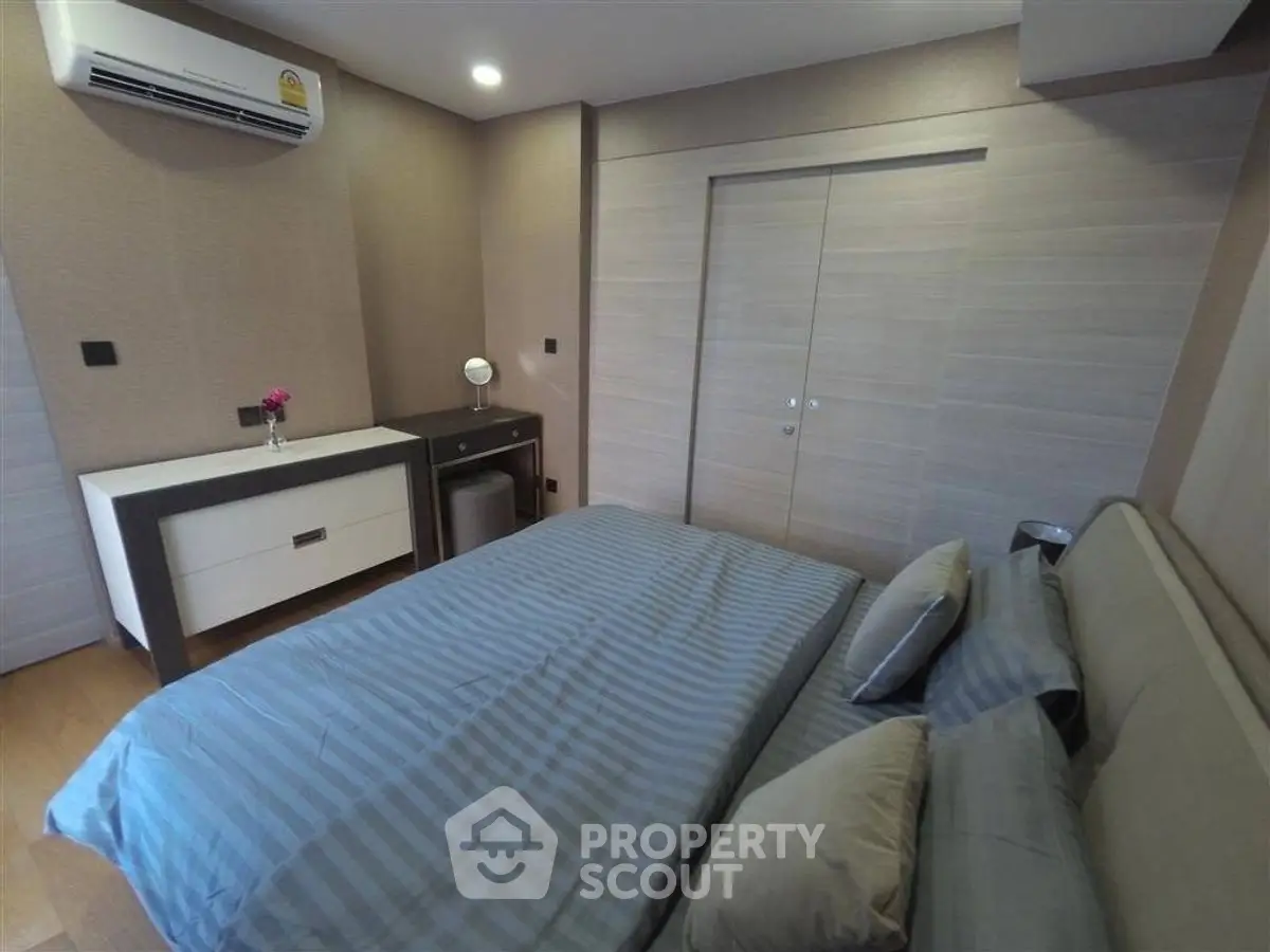 Modern bedroom with stylish decor and air conditioning unit