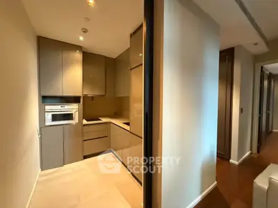 Modern kitchen with sleek cabinetry and built-in appliances in a stylish apartment.