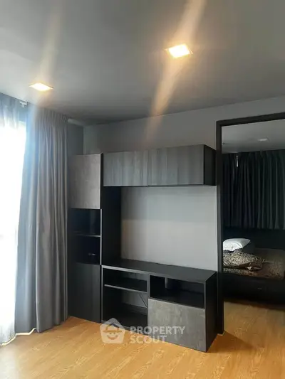 Modern apartment interior with sleek built-in storage and cozy bedroom view.