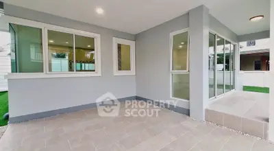 Modern patio with large windows and tiled flooring in a contemporary home