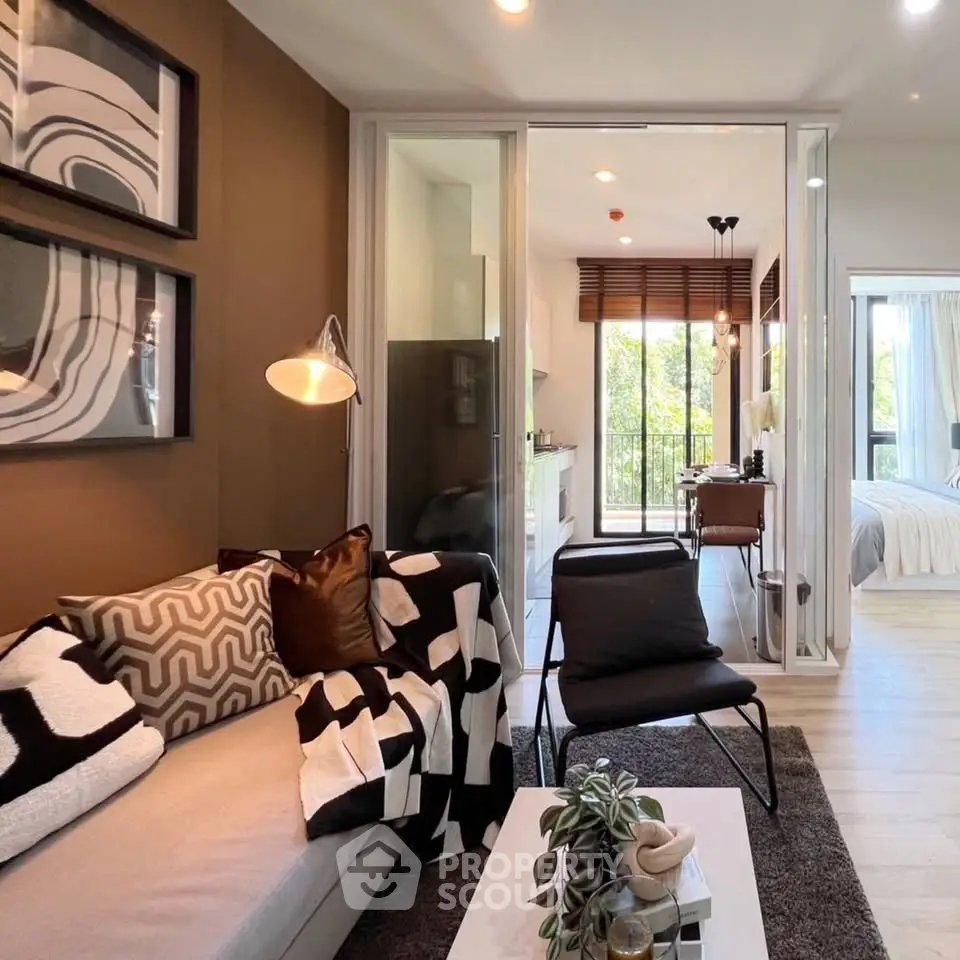 Modern living room with stylish decor and open layout leading to a bright bedroom.