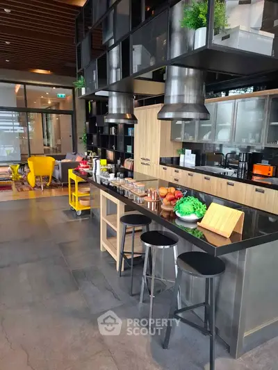 Modern kitchen with sleek black countertops and open shelving in a stylish apartment.