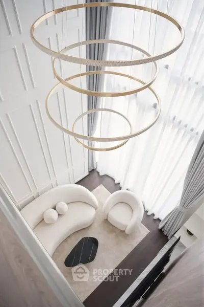 Luxurious modern living room with high ceilings and elegant chandelier