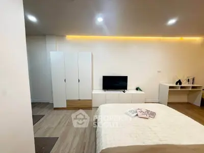 Modern bedroom with sleek furniture and ambient lighting, perfect for cozy living.