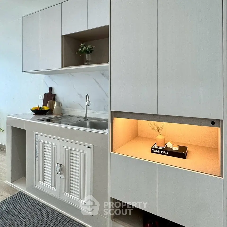 Modern kitchen with sleek cabinetry and integrated lighting, featuring a stylish open layout and contemporary design.