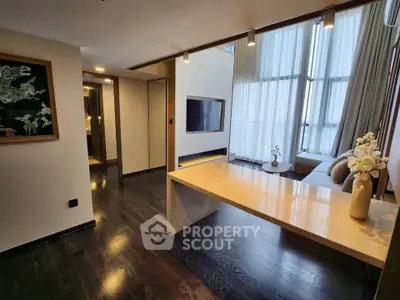 Modern living room with elegant decor and floor-to-ceiling windows
