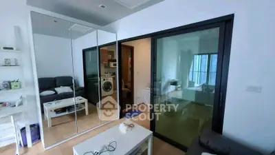Modern apartment interior with mirrored wardrobe and sliding glass doors