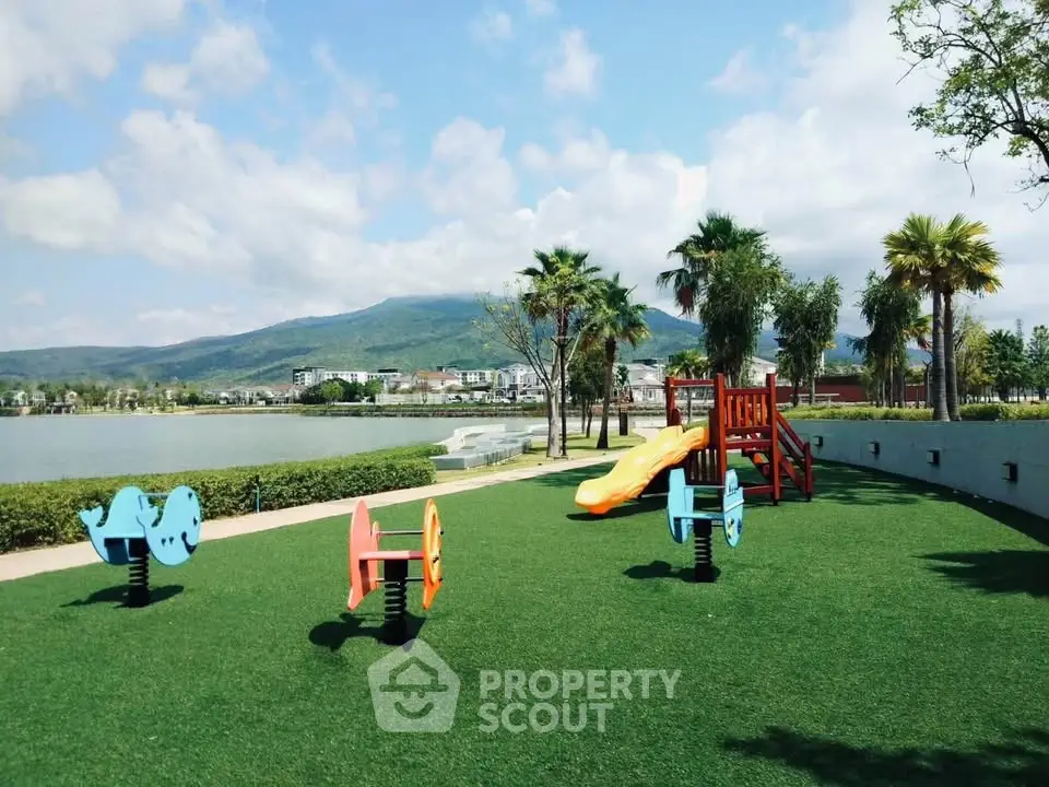 Scenic playground with vibrant equipment and stunning mountain view, perfect for family-friendly real estate.