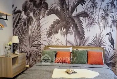 Stylish bedroom with tropical wallpaper and cozy decor