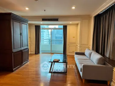 Spacious living room with elegant wooden flooring and city view balcony.