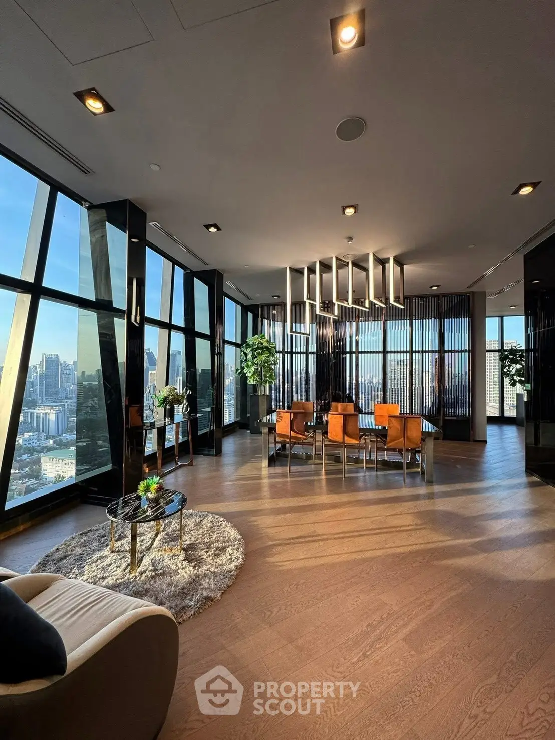 Luxurious modern living room with panoramic city views and elegant decor.