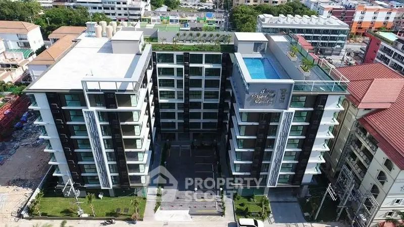 Modern apartment building with rooftop pool and lush greenery, offering urban living with luxury amenities.