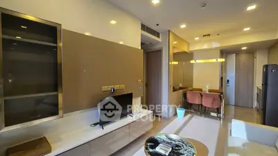 Modern living room with sleek furniture and ambient lighting in a contemporary apartment.