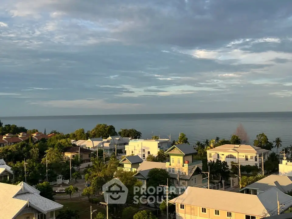 Stunning coastal view from a high vantage point showcasing serene residential area and ocean horizon.