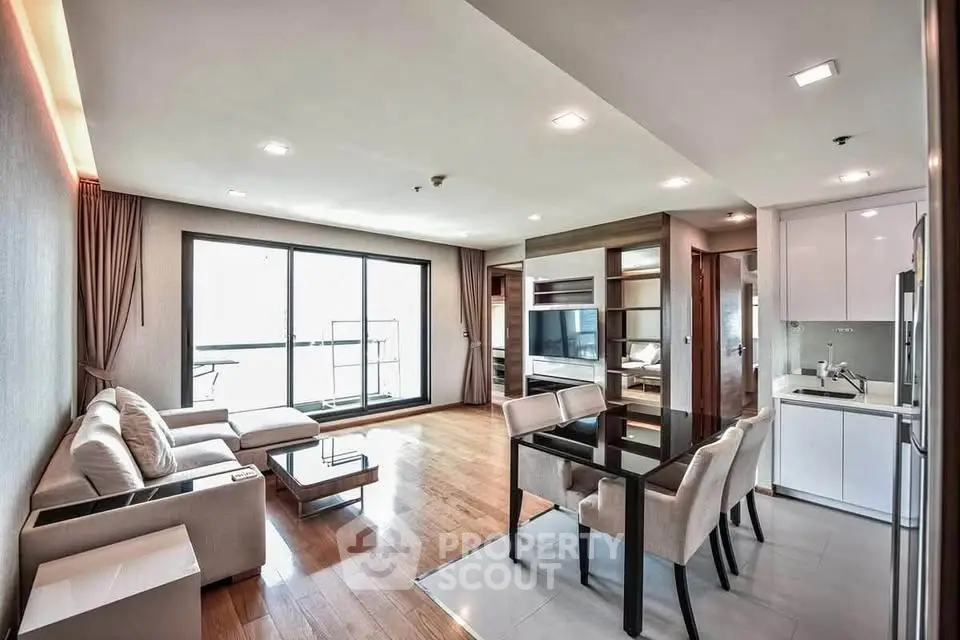 Spacious modern living room with open kitchen and large windows in luxury apartment