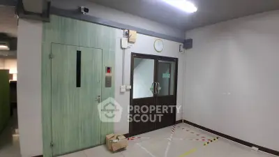 Spacious building entrance with elevator and secure access doors