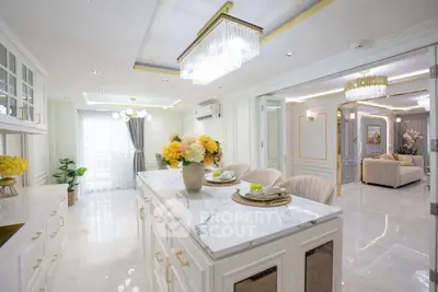 Luxurious open-plan kitchen and living room with elegant decor and marble island