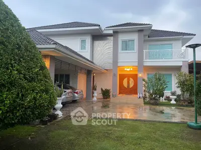 Stunning two-story modern home with lush landscaping and elegant entrance, perfect for luxury living.