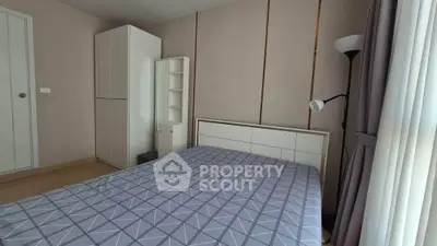 Modern bedroom with geometric bedding and sleek storage solutions.