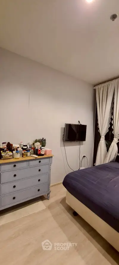 Cozy bedroom with modern decor and wall-mounted TV