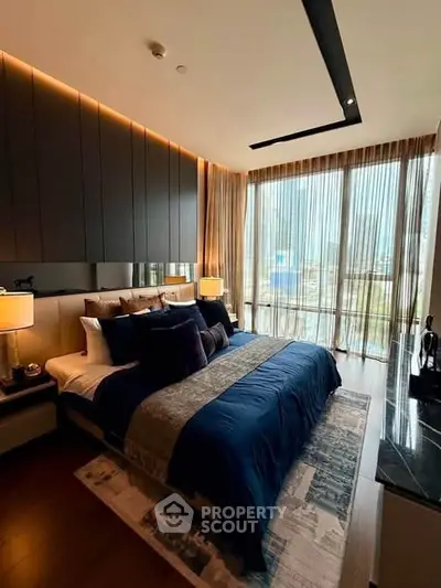 Luxurious bedroom with floor-to-ceiling windows and elegant decor in modern apartment.