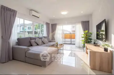 Bright and spacious living room with modern decor and large windows in a stylish home.