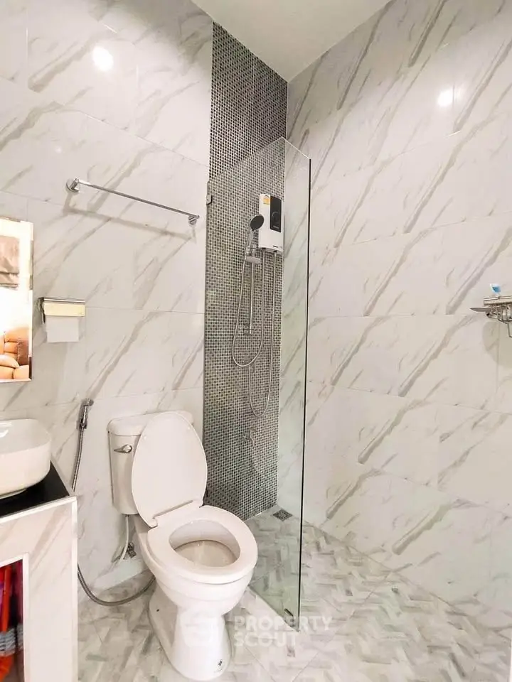 Modern bathroom with sleek shower and marble tiles