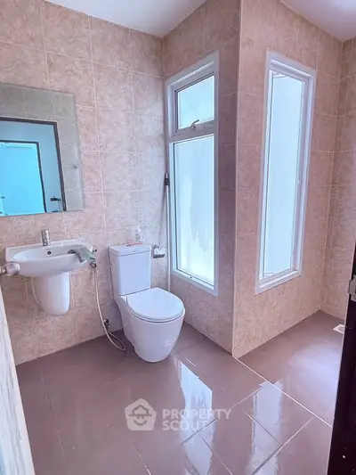 Modern bathroom with sleek fixtures and large windows for natural light.