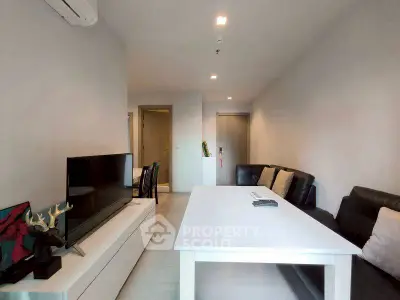 Modern living room with sleek furniture and flat-screen TV, perfect for relaxation and entertainment.