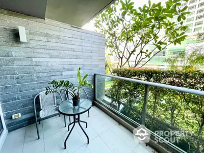 Charming balcony with lush greenery and modern outdoor seating